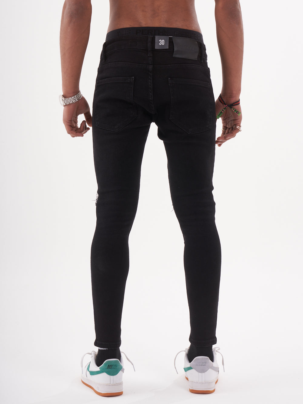 The back view of a man wearing HELLFIRE | BLUE jeans.