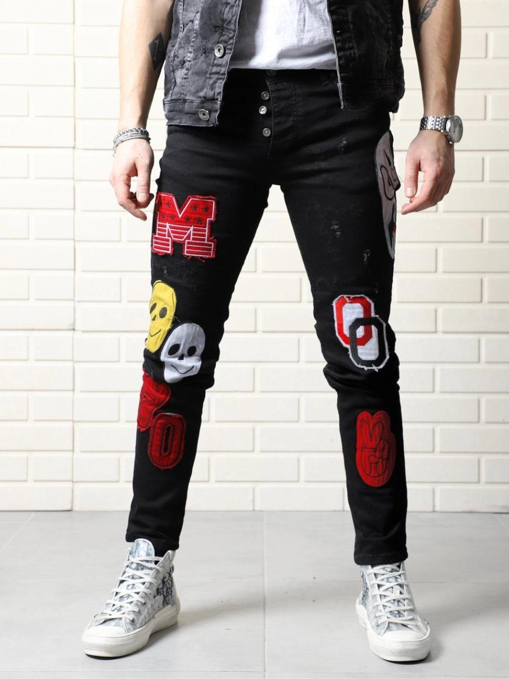 A man wearing a CLOWN CAR with patches on them.