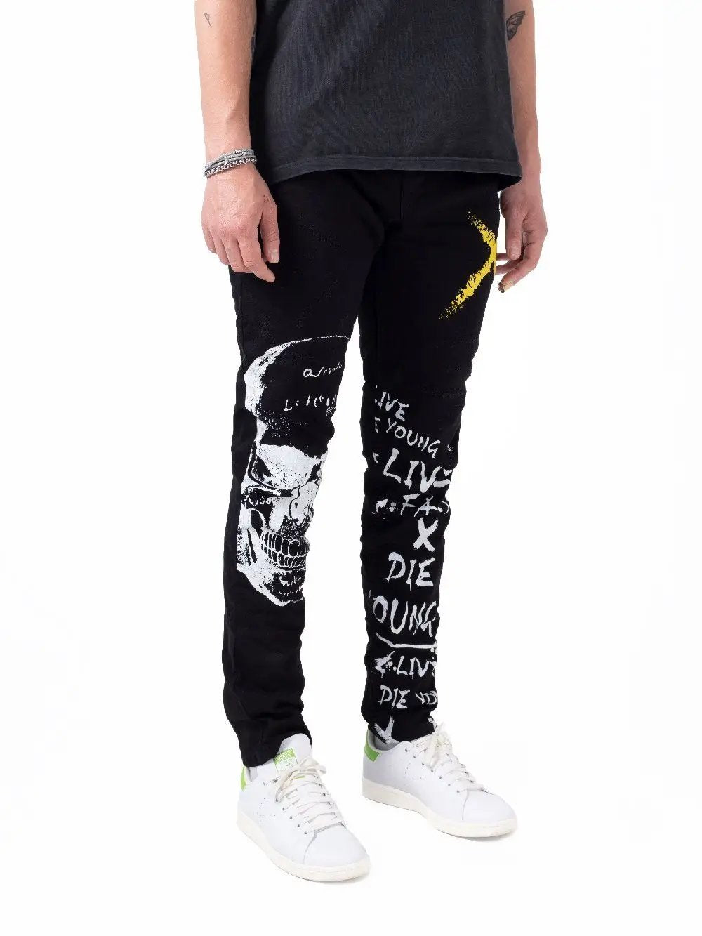 A man wearing a DEAN t - shirt and jeans.