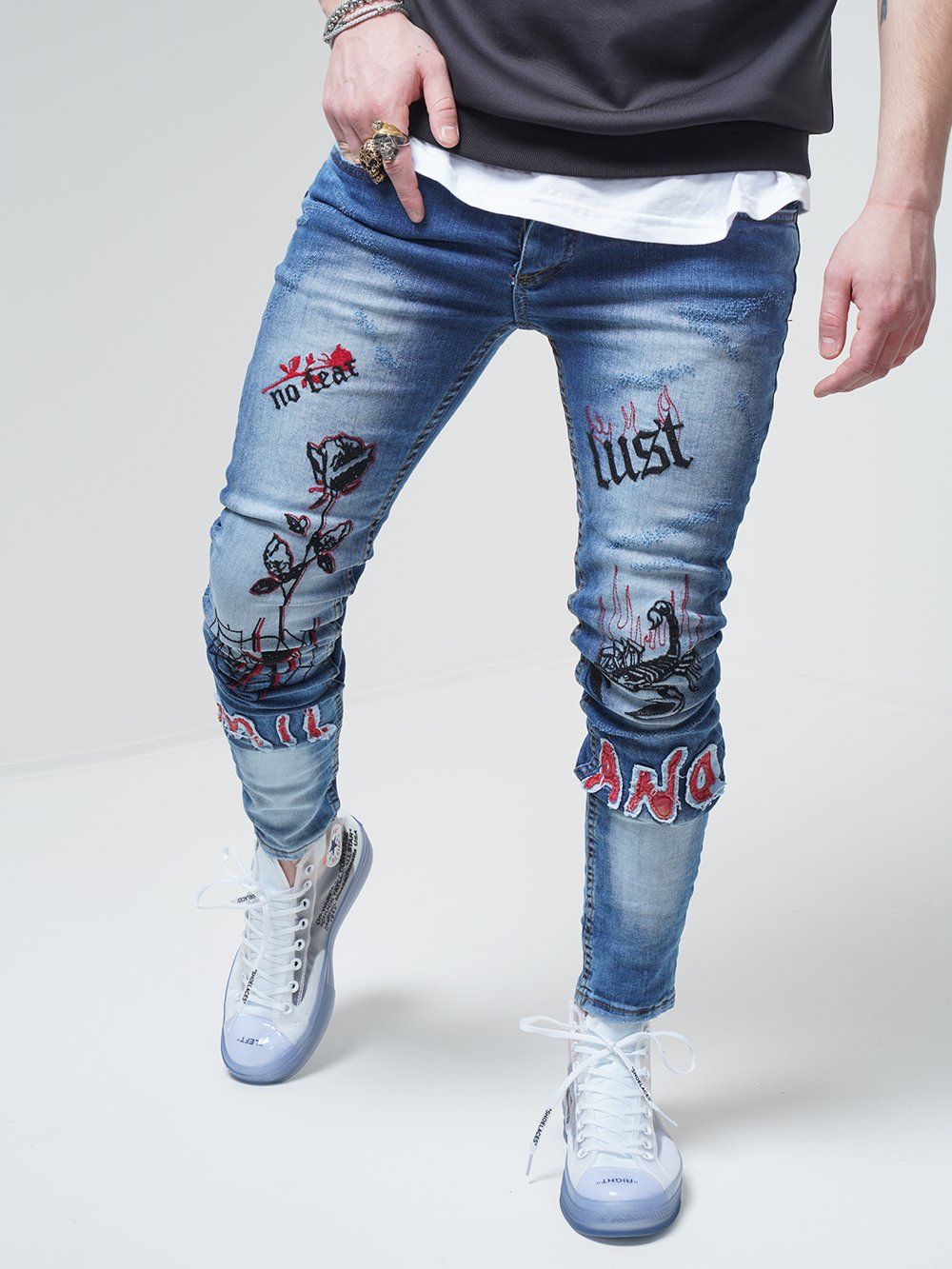 Lower body shot of a man wearing ROSE TATTOO skinny jeans