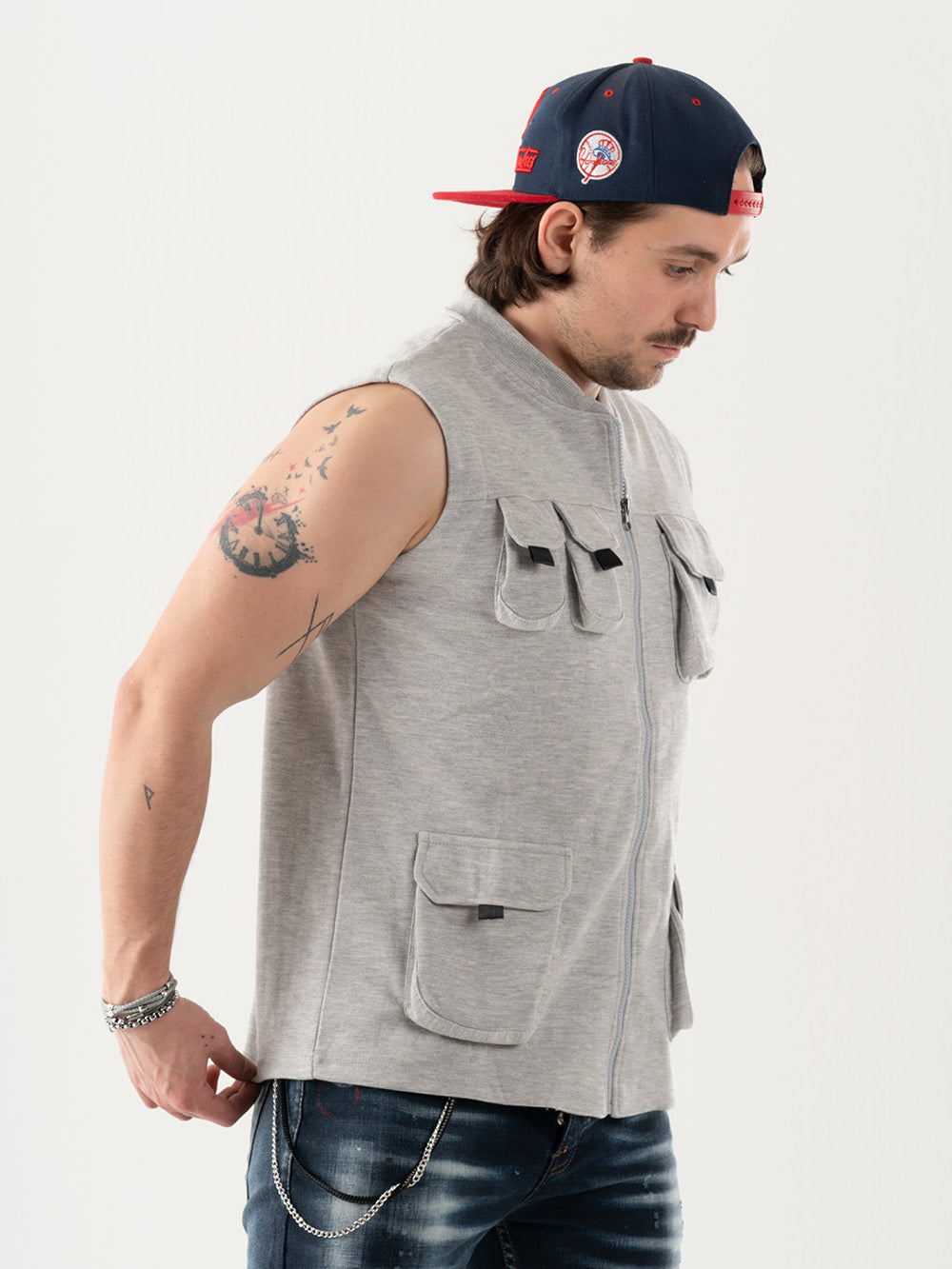 A man wearing a FREESPIRIT VEST with cargo pockets and a hat.