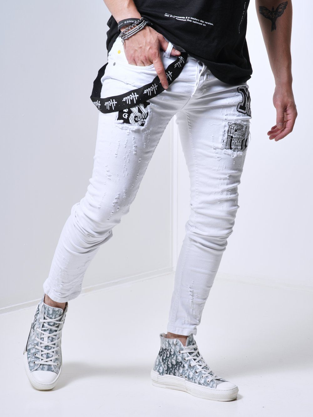 A man wearing MASSIVE jeans and a black t-shirt.