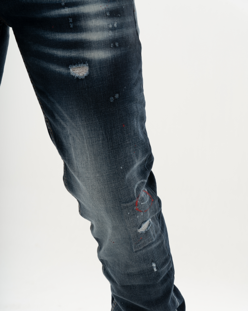 A man wearing a pair of LIGHTNING with holes in them.