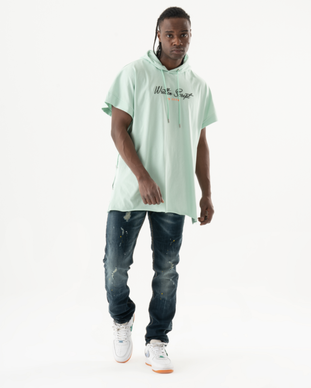 A man wearing a KUDOS hoodie and jeans.