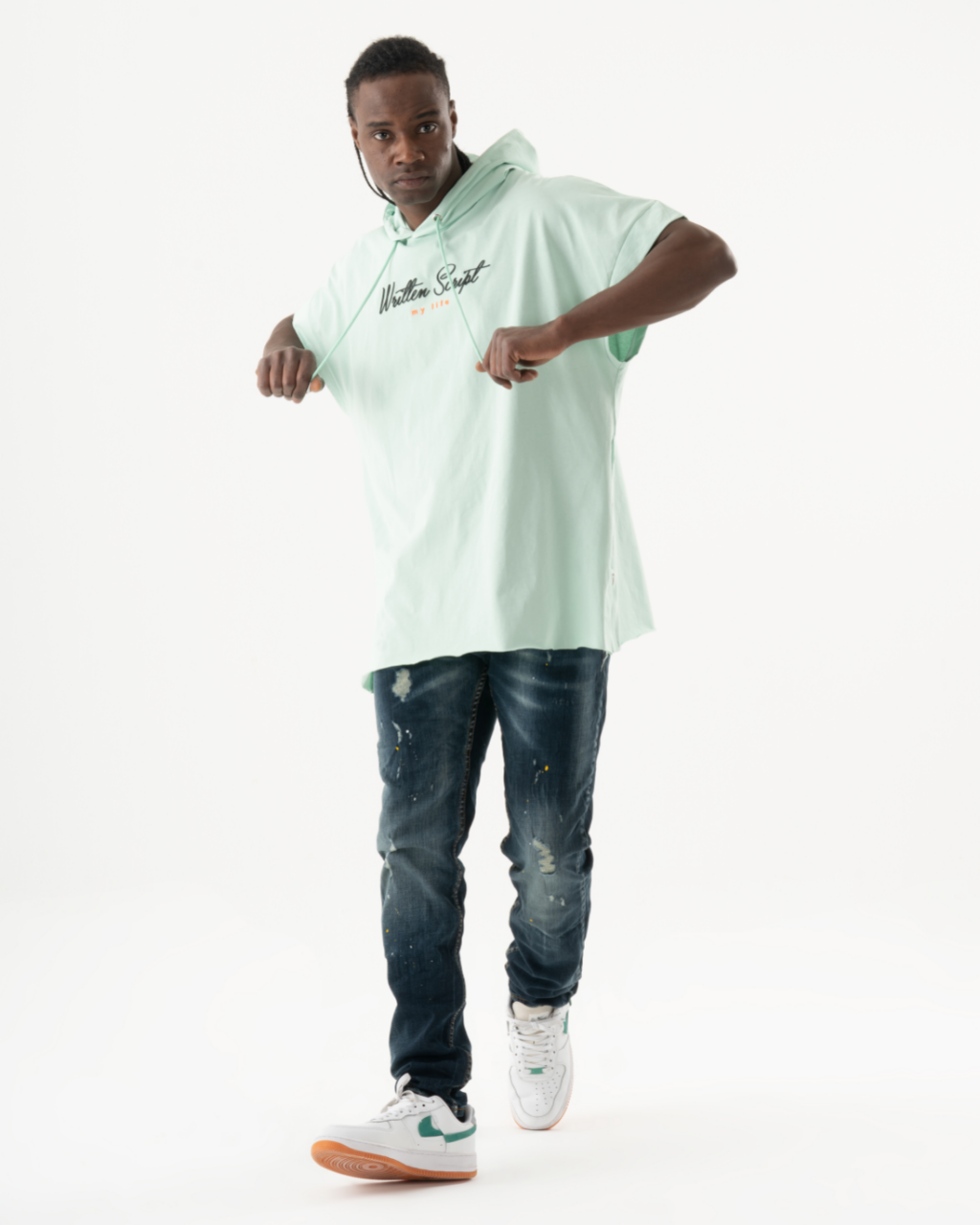 A young man wearing a KUDOS hoodie and jeans.