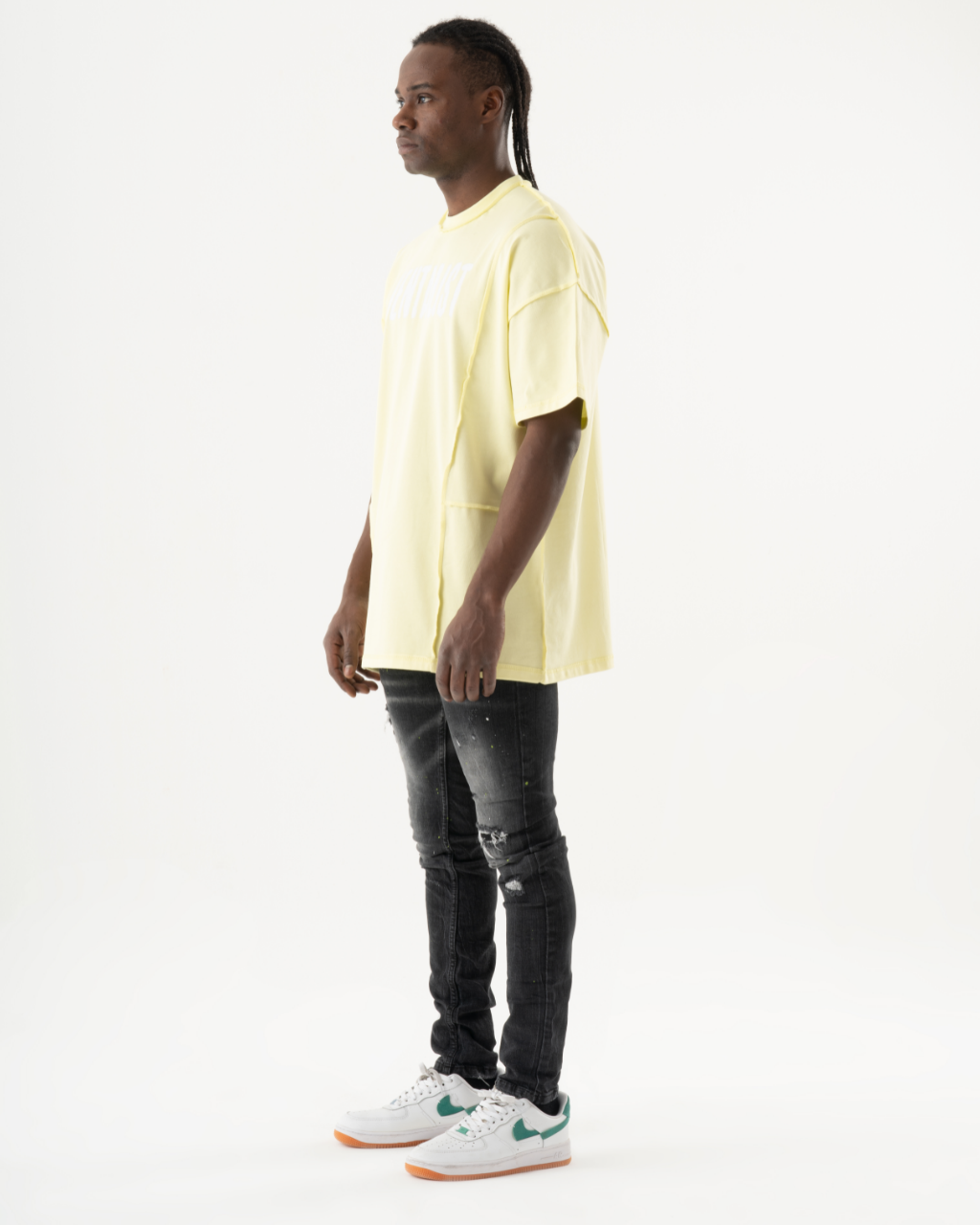 A man wearing INKLING skinny-fit black jeans.