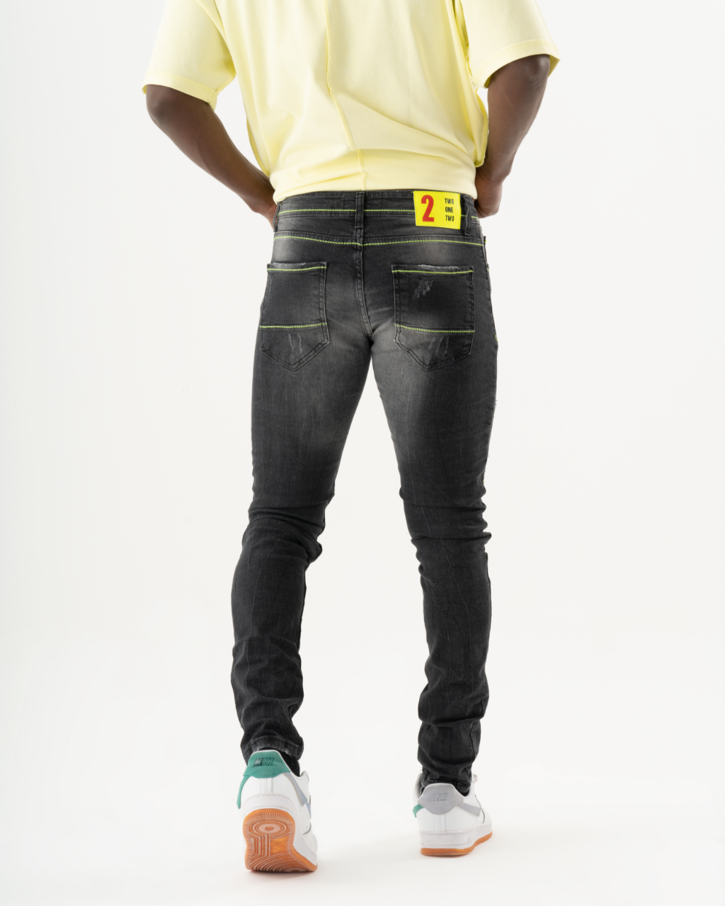 A man wearing black INKLING skinny jeans.