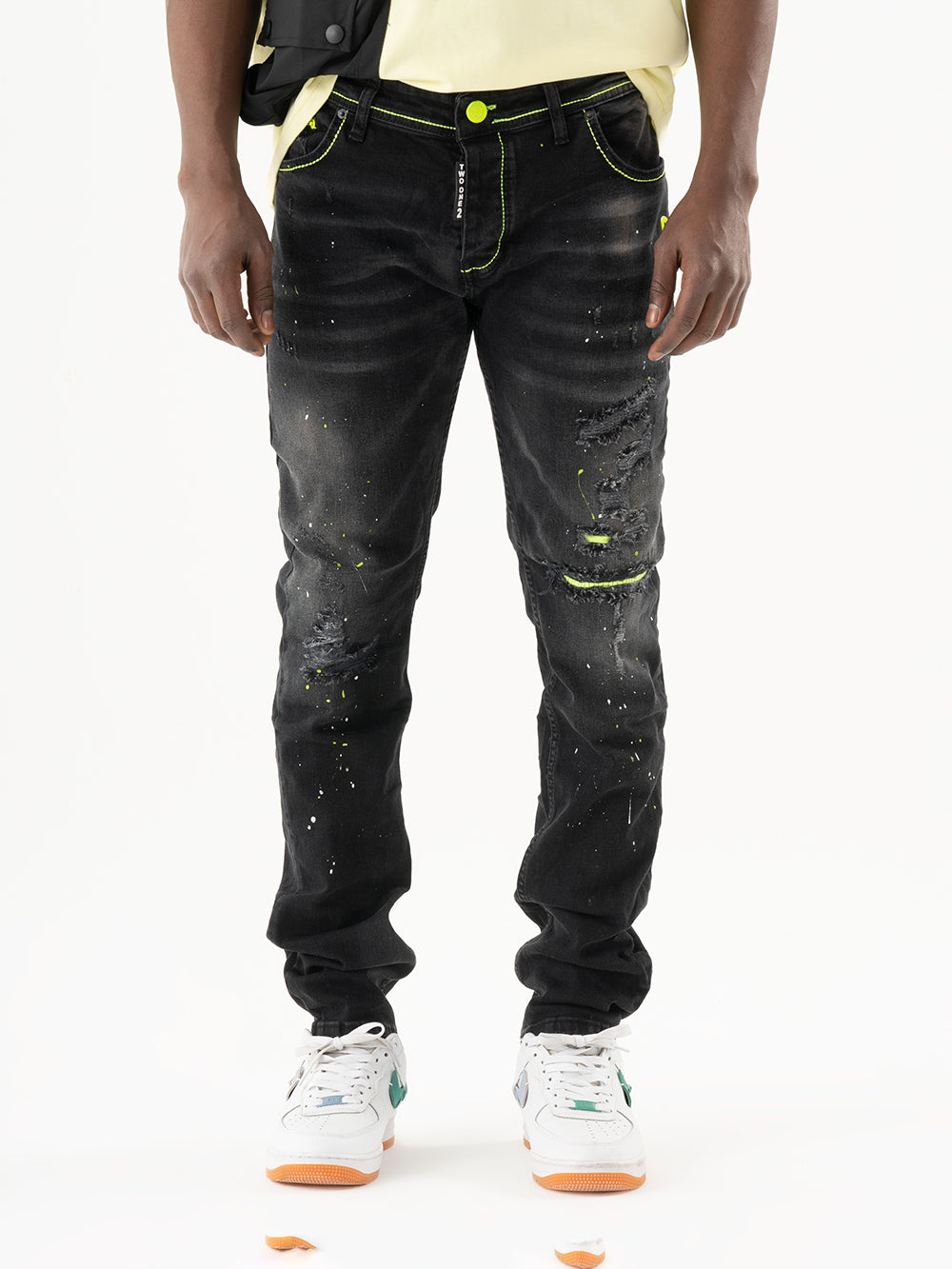 A man wearing ripped jeans and carrying a yellow TWILIGHT.