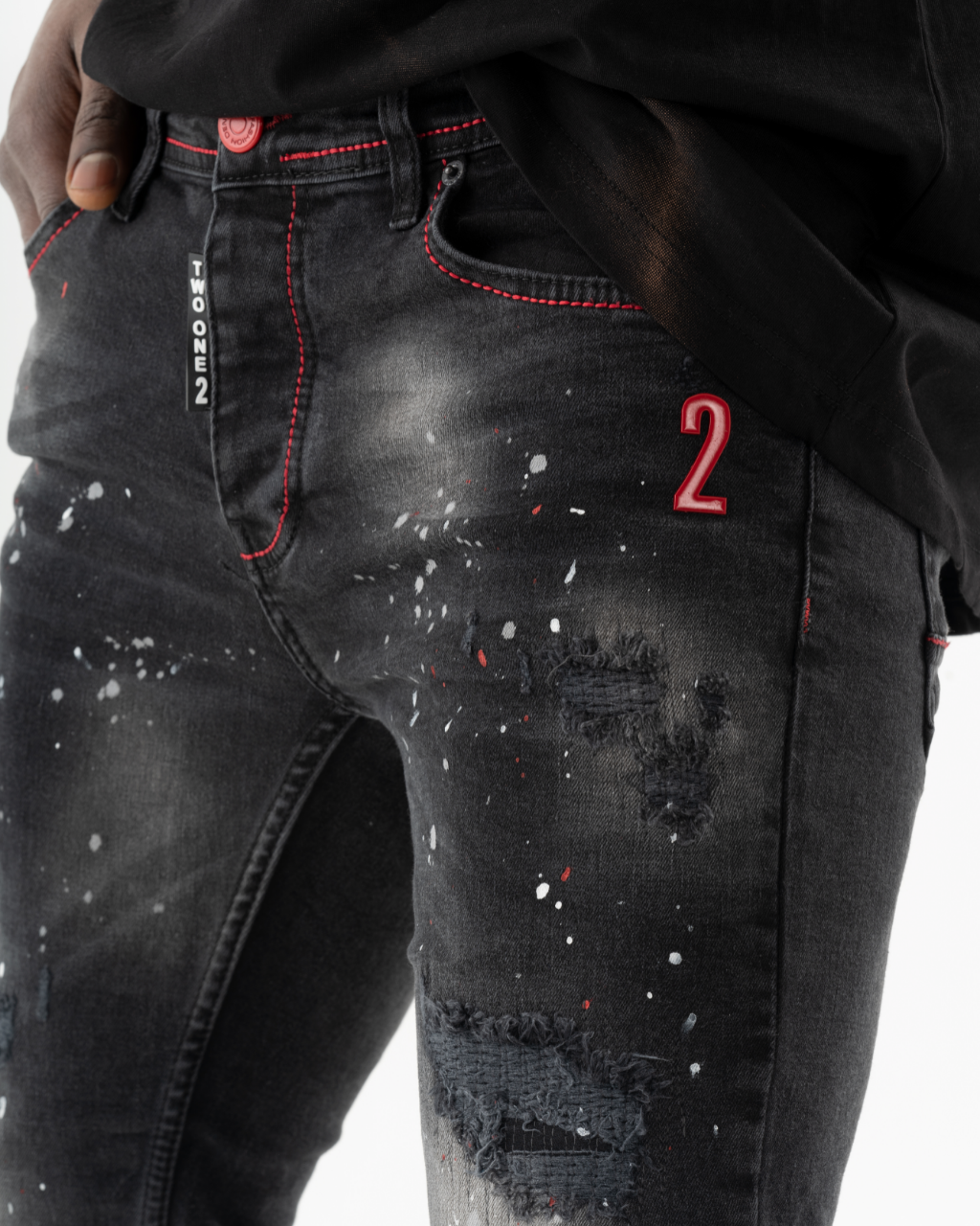 A man wearing a pair of HOTSPOT with red paint splatters.