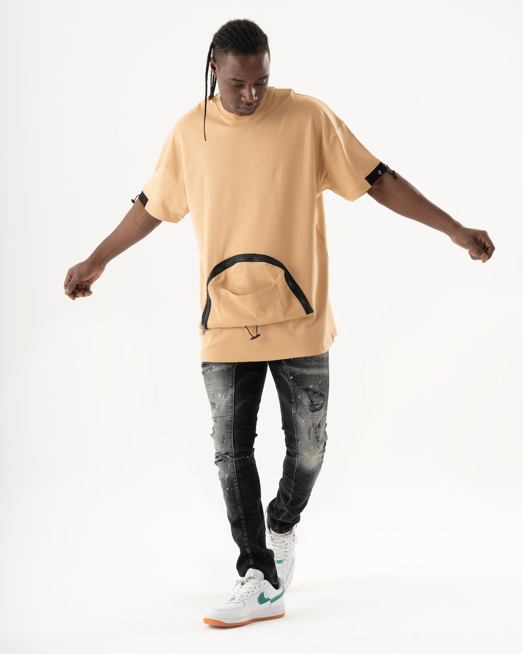 A man wearing an ENRAGE t-shirt, the elastic fabric giving it a smooth feel.