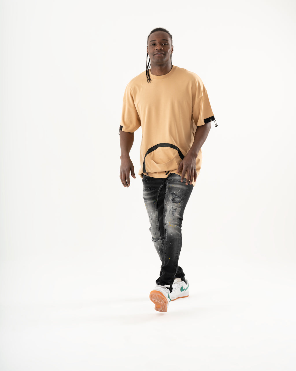 A man wearing an ENRAGE t-shirt and jeans in a skinny fit.