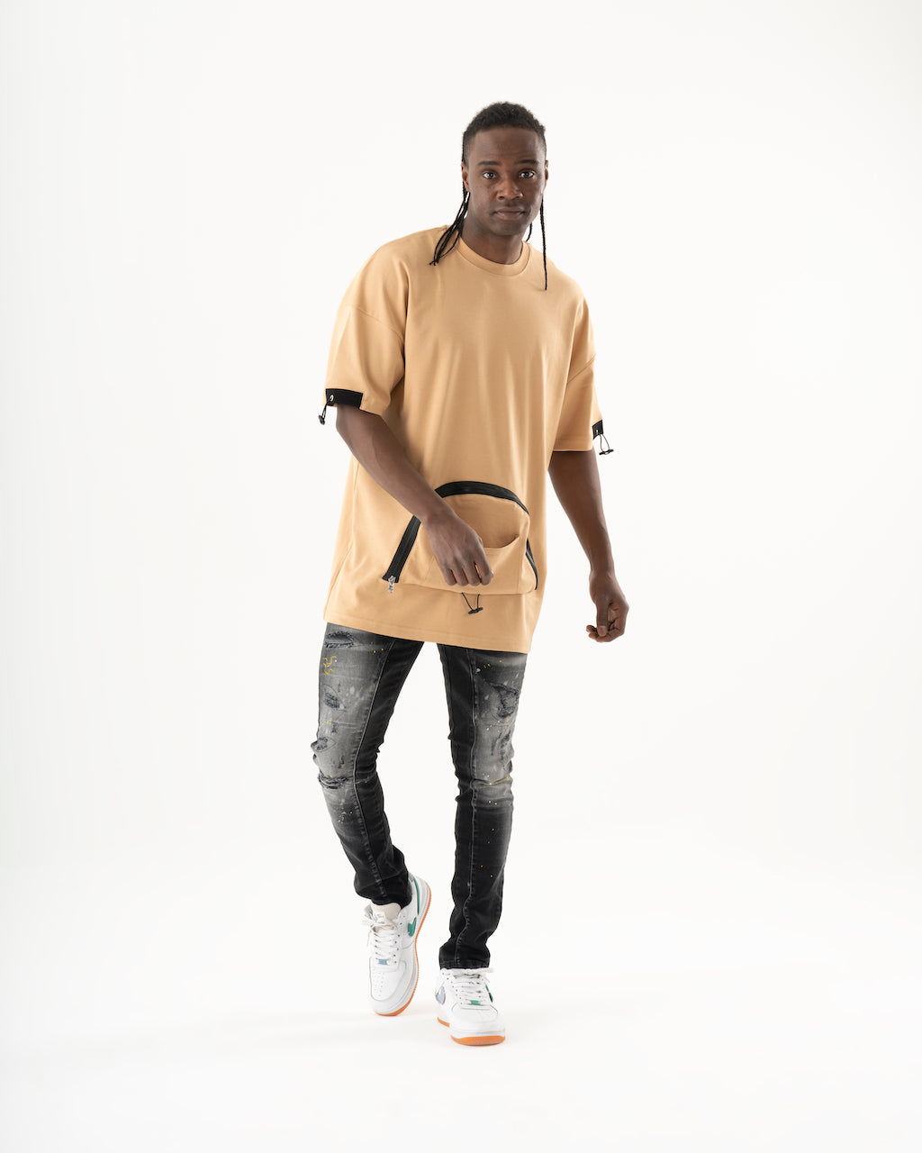 A man wearing an ENRAGE t-shirt and skinny fit jeans.