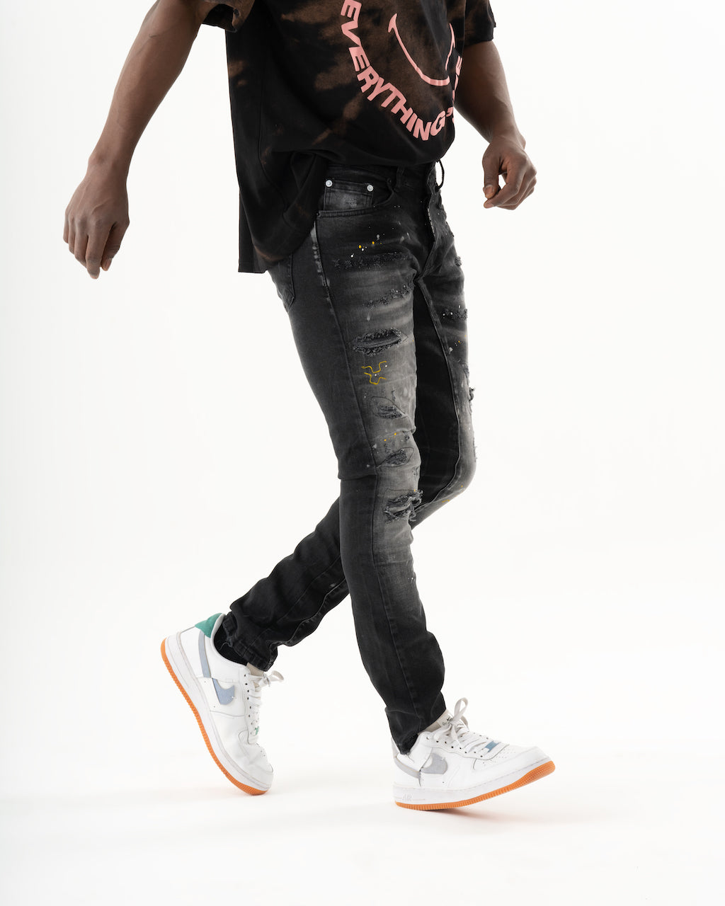 A man wearing a black t-shirt made of ENRAGE, smooth feel fabric.