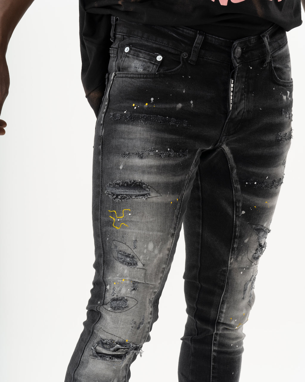 A man sporting ENRAGE skinny fit black jeans and an ENRAGE smooth feel t-shirt.