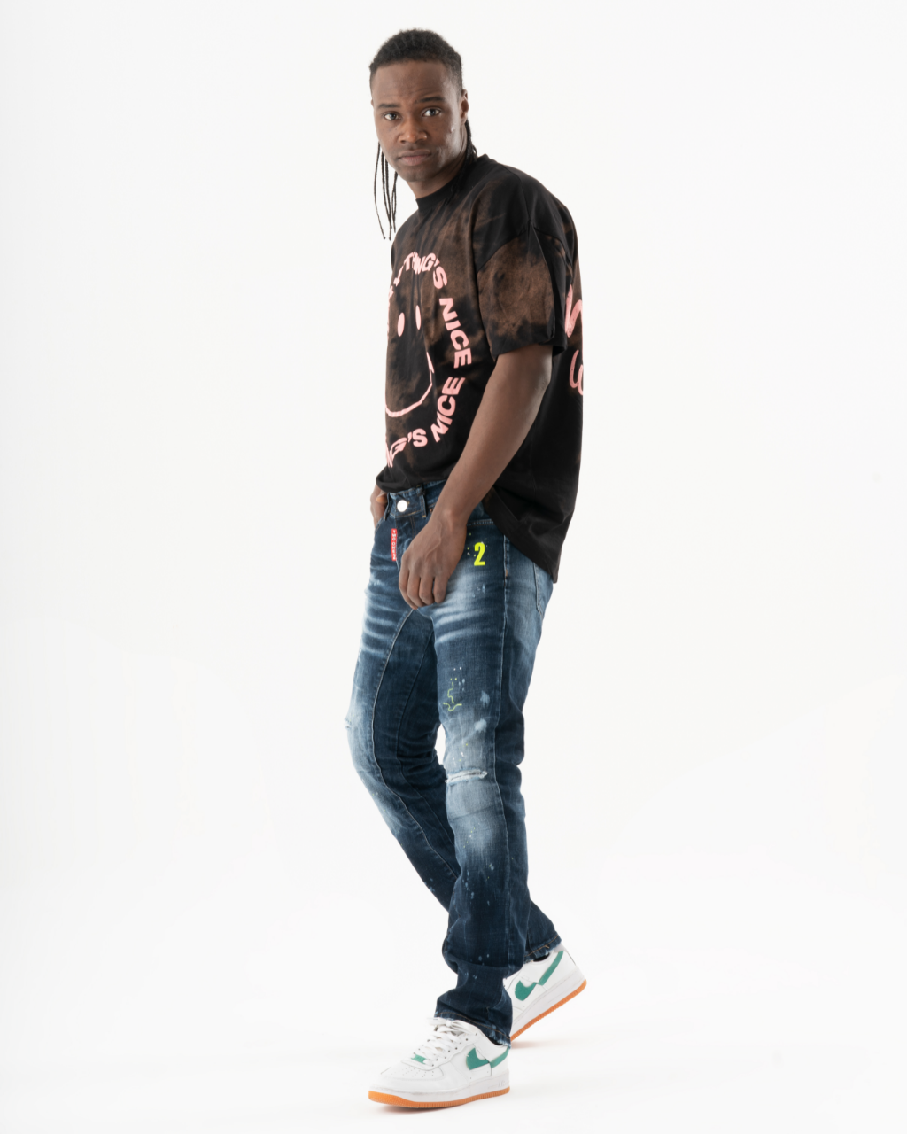 A man in INCOGNITO jeans and a t-shirt.