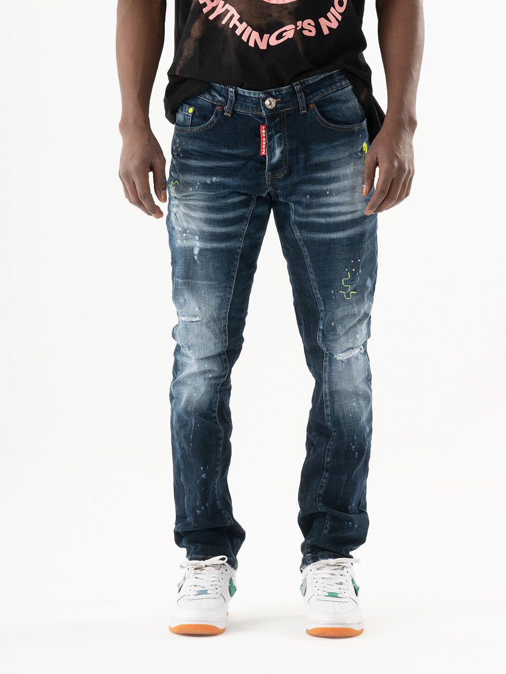 A man wearing an INCOGNITO t-shirt and jeans.