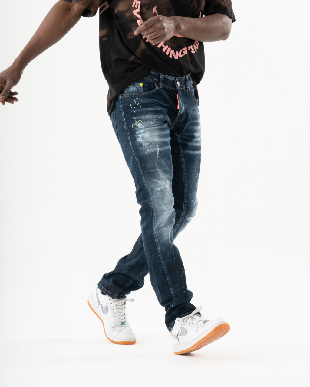 A man wearing an INCOGNITO t-shirt and jeans.