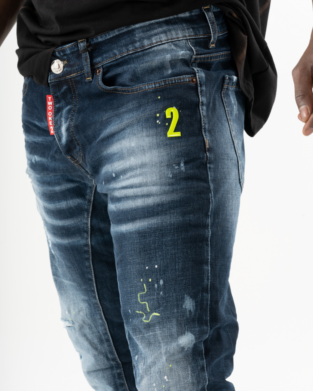 A man wearing a pair of INCOGNITO with the number 2 painted on them.