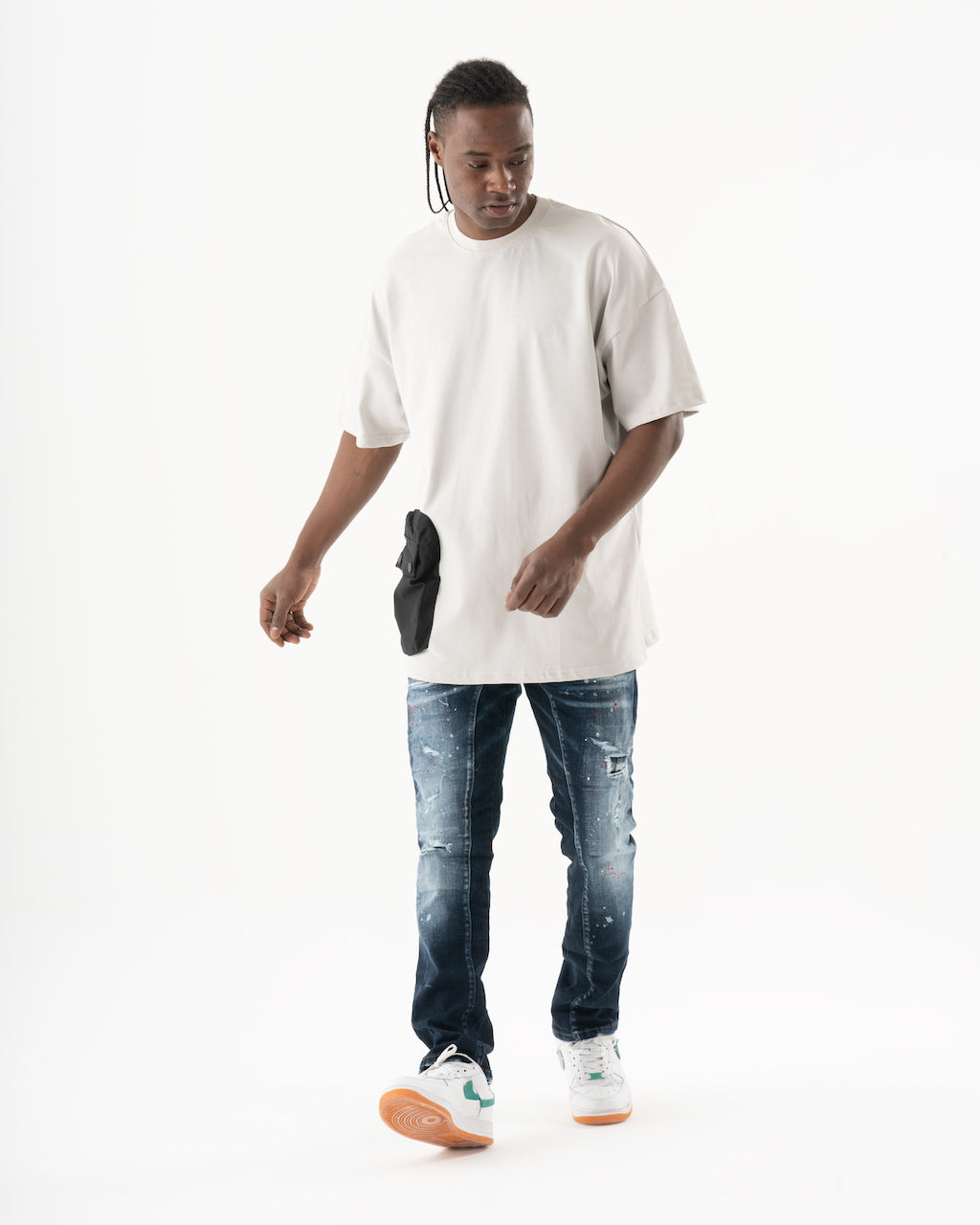 A man wearing a STARLIGHT t - shirt and jeans.