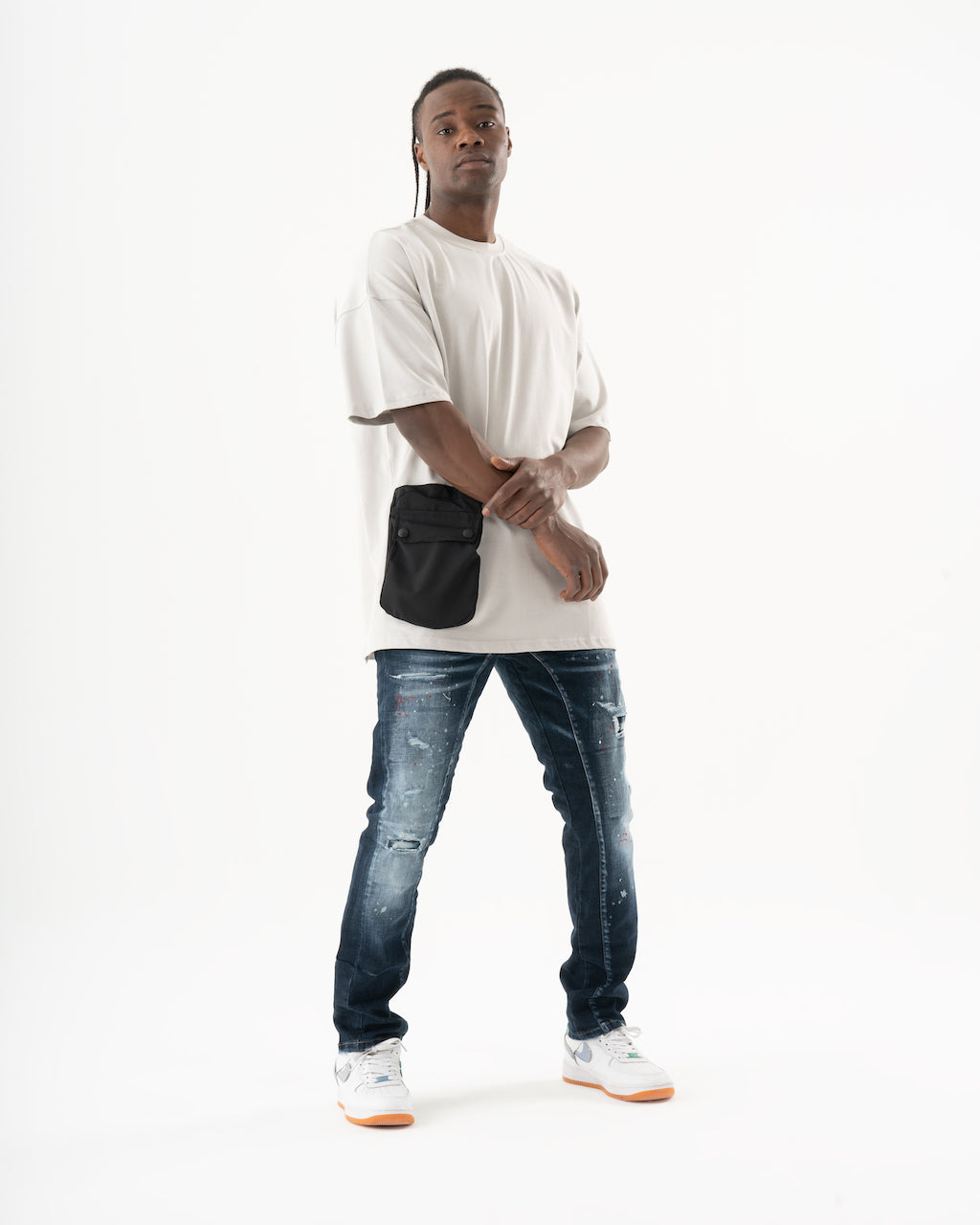 A man wearing a white STARLIGHT t-shirt and jeans.