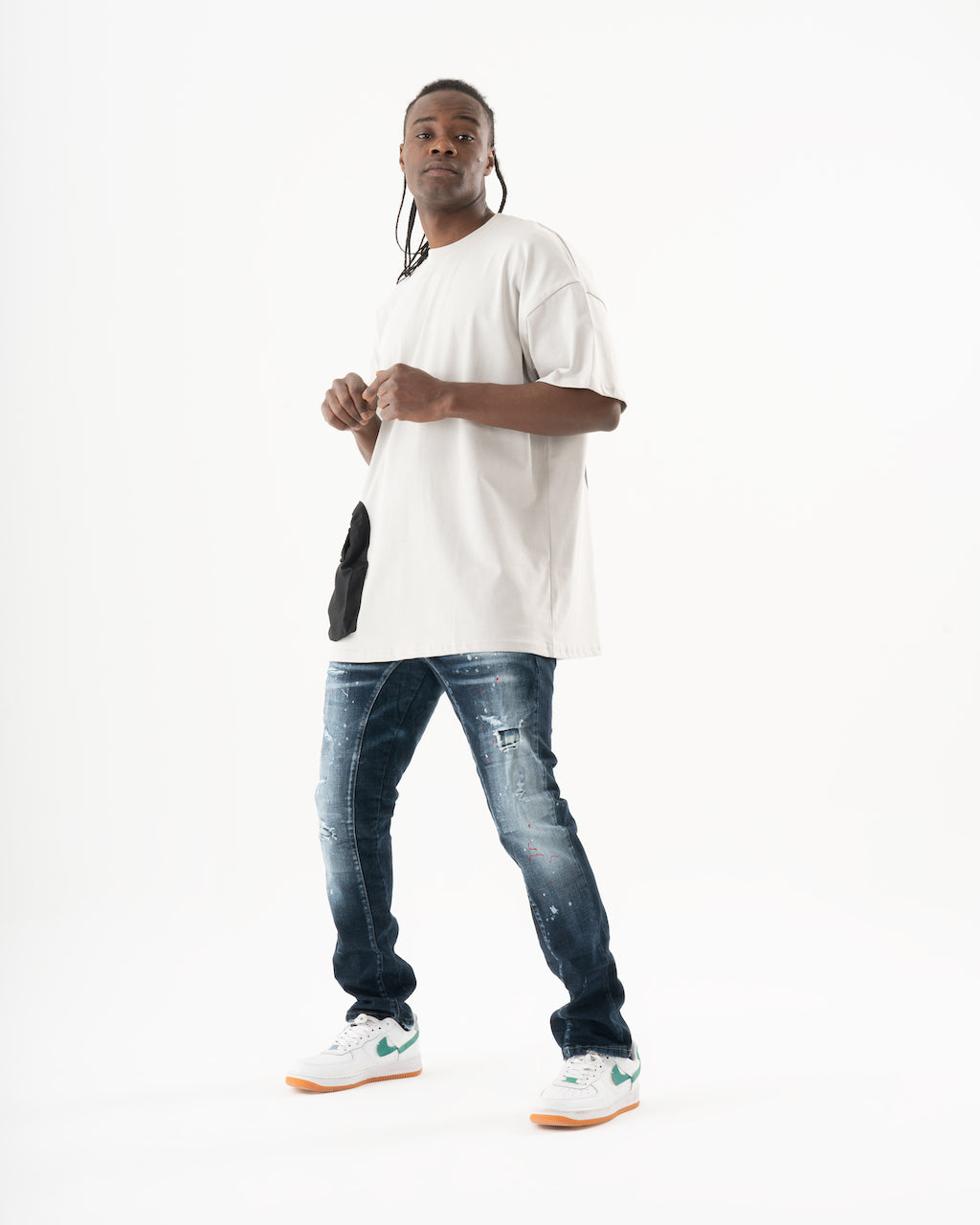 A man wearing a STARLIGHT white t - shirt and jeans.