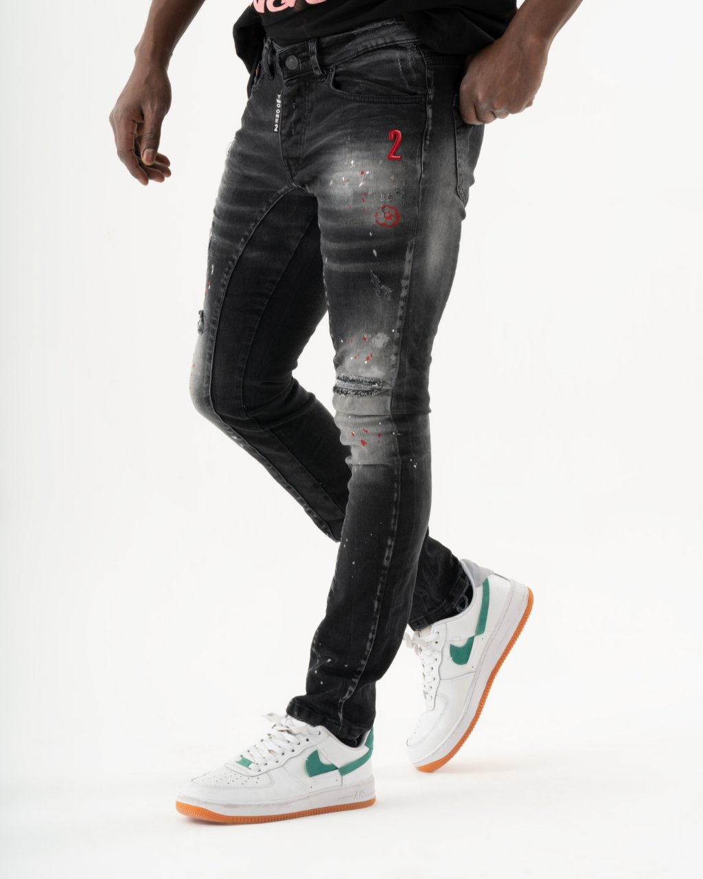 A man wearing THUNDERBIRD jeans with added stretch and white sneakers.