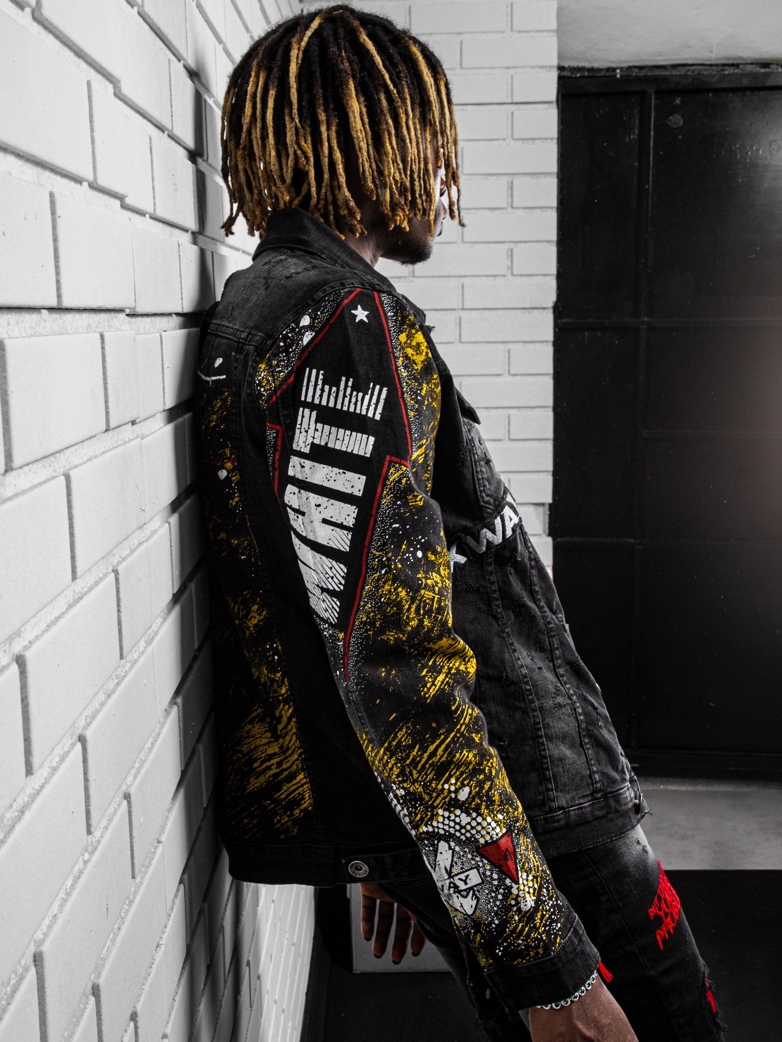 Side shot of a man with long hair wearing THE CAPTAIN Denim Jacket by SERNES