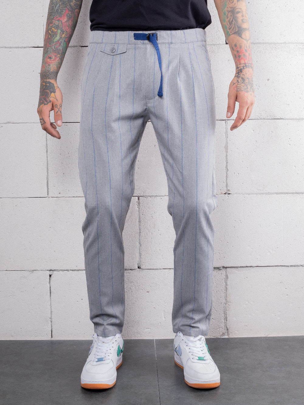 A hand-crafted man wearing RODEO DRIVE PANTS with an elastic belt.