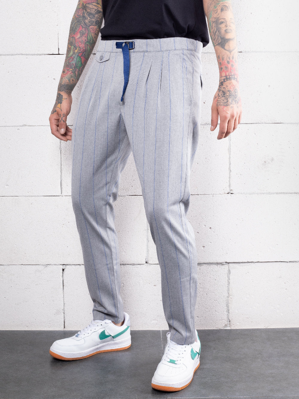 A man wearing RODEO DRIVE PANTS with an elastic belt.
