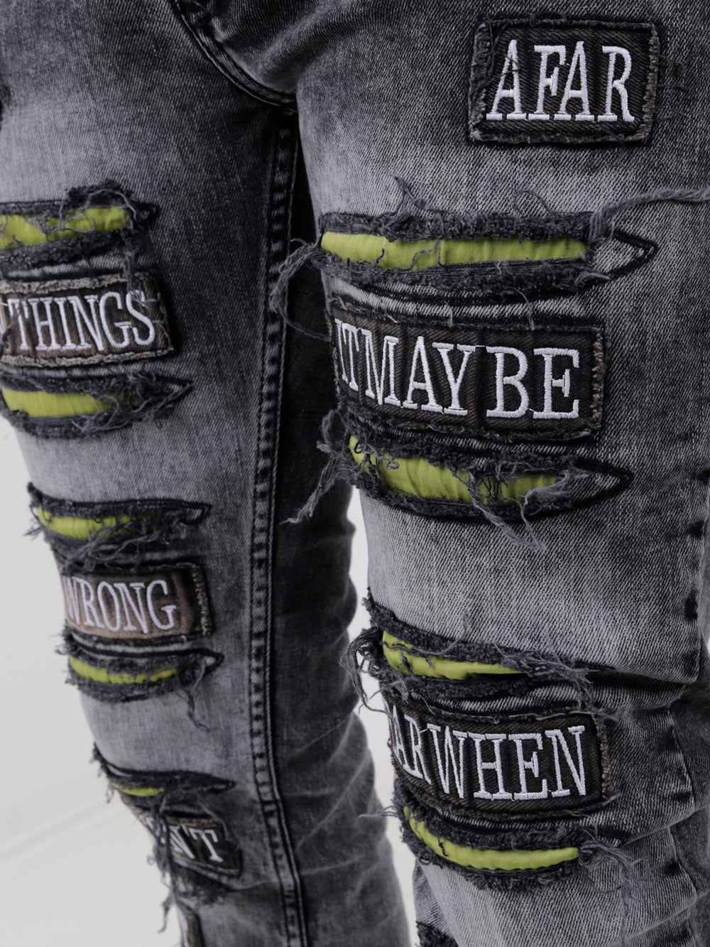 A pair of IMPROPER with patches on them that say 'afraid'.