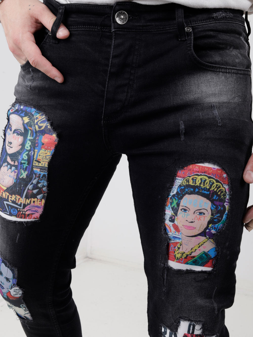 A man is wearing a pair of MOONLISA jeans with a picture of queen elizabeth.