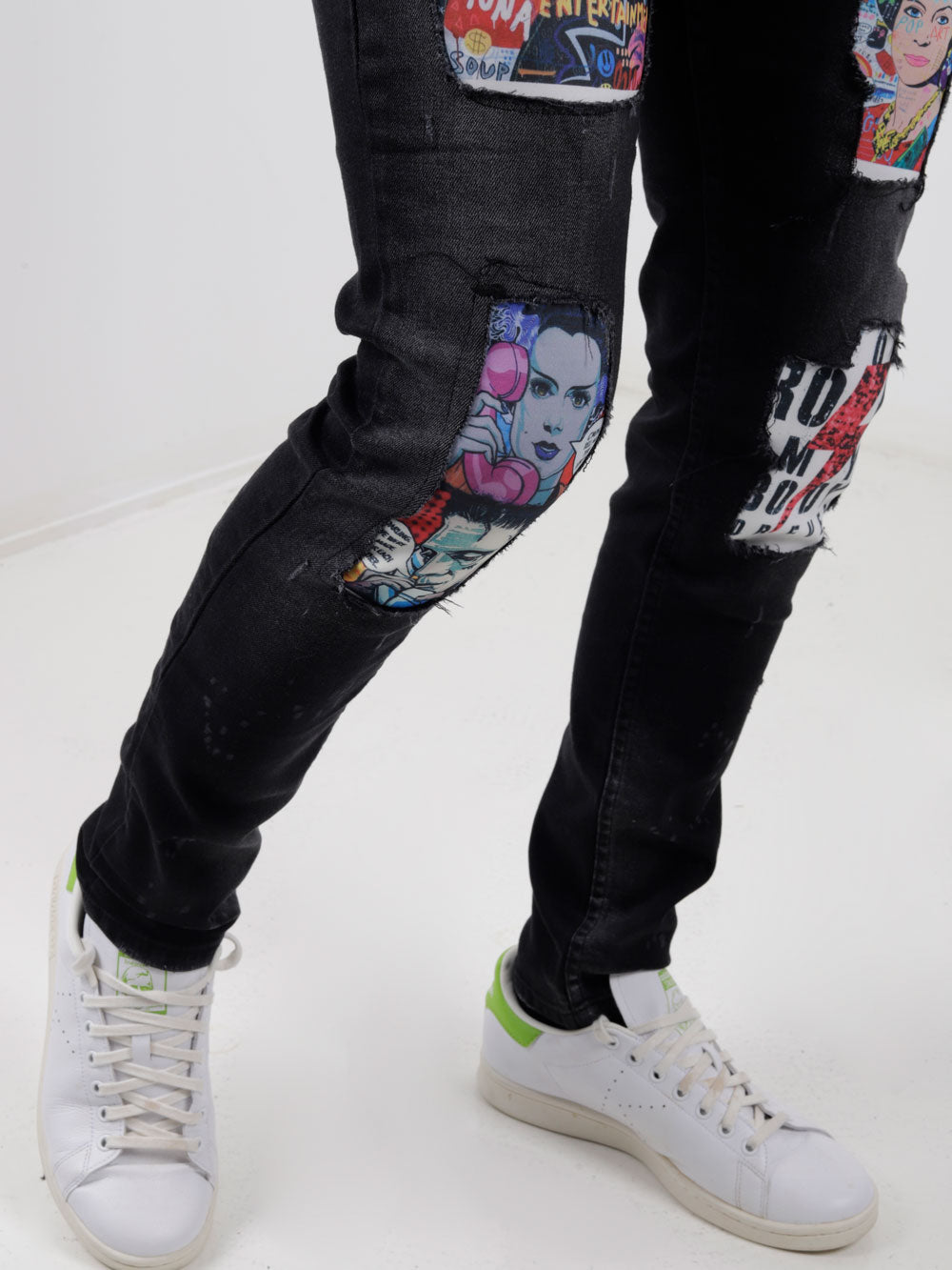 A man wearing a pair of MOONLISA jeans with patches on them.