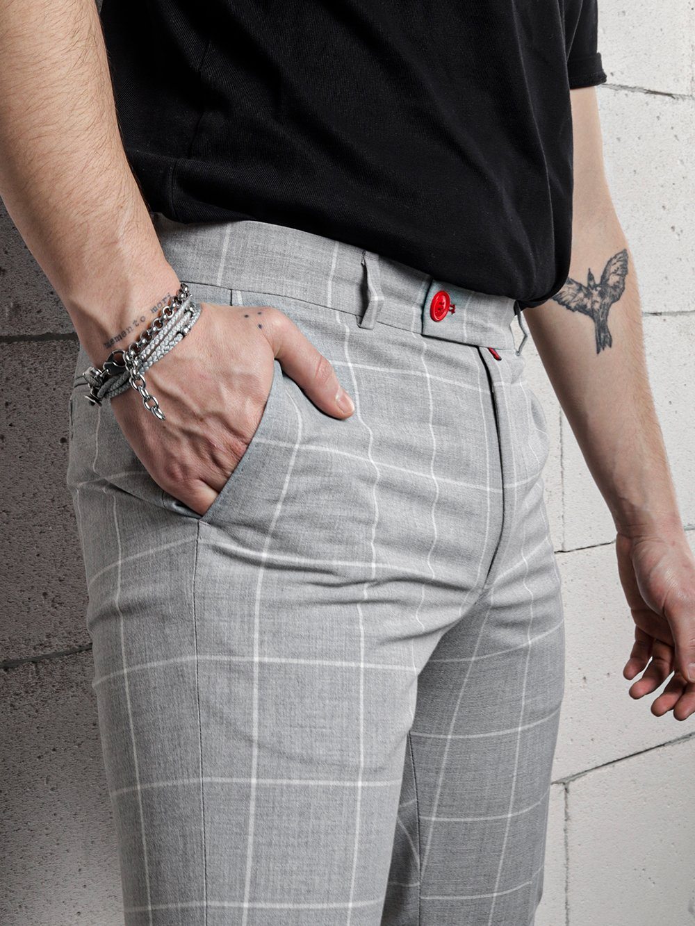 A man wearing ICED AMERICANO PANTS and a black shirt.