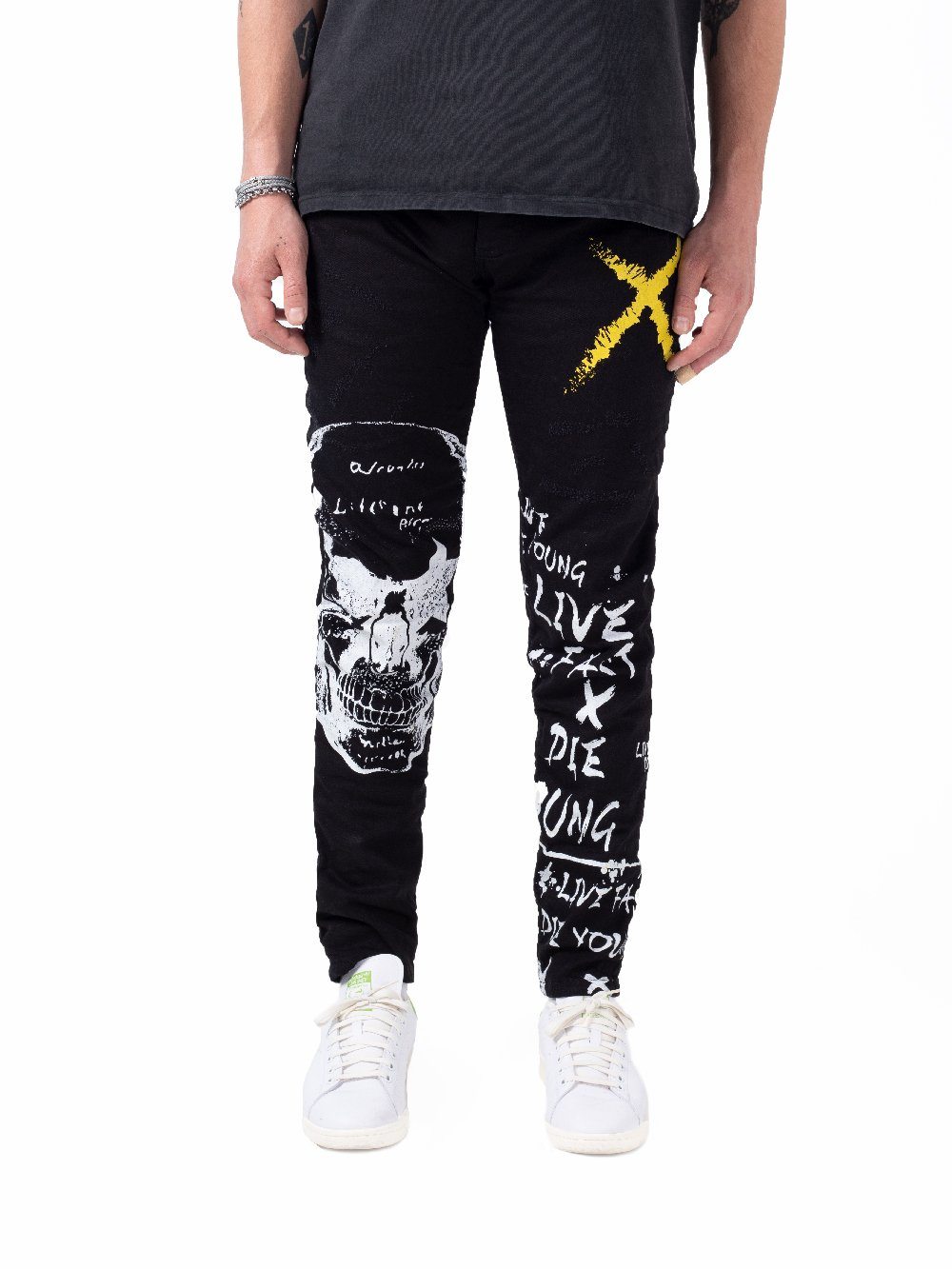 A man wearing a DEAN t - shirt and a pair of black sweatpants.