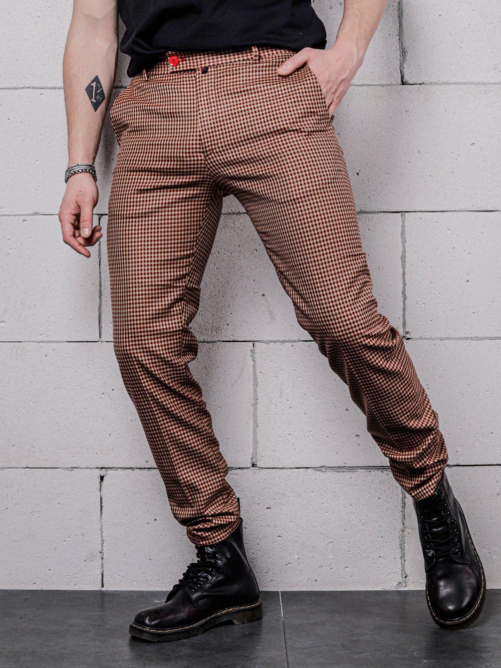 A man in Java Chip Pants and a black shirt is posing.