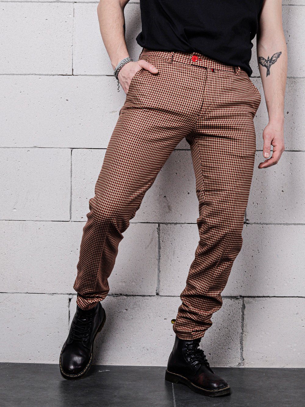 A man wearing skinny fit black shirt and JAVA CHIP PANTS.