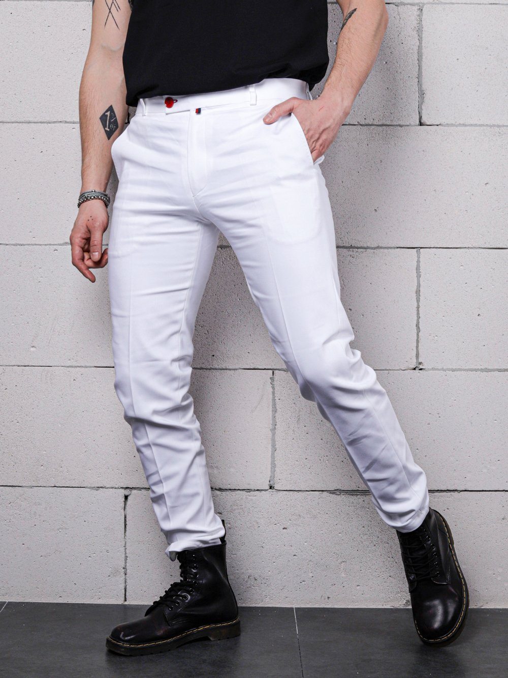 A man wearing CREAM FRAPPUCCINO pants and a black t - shirt.