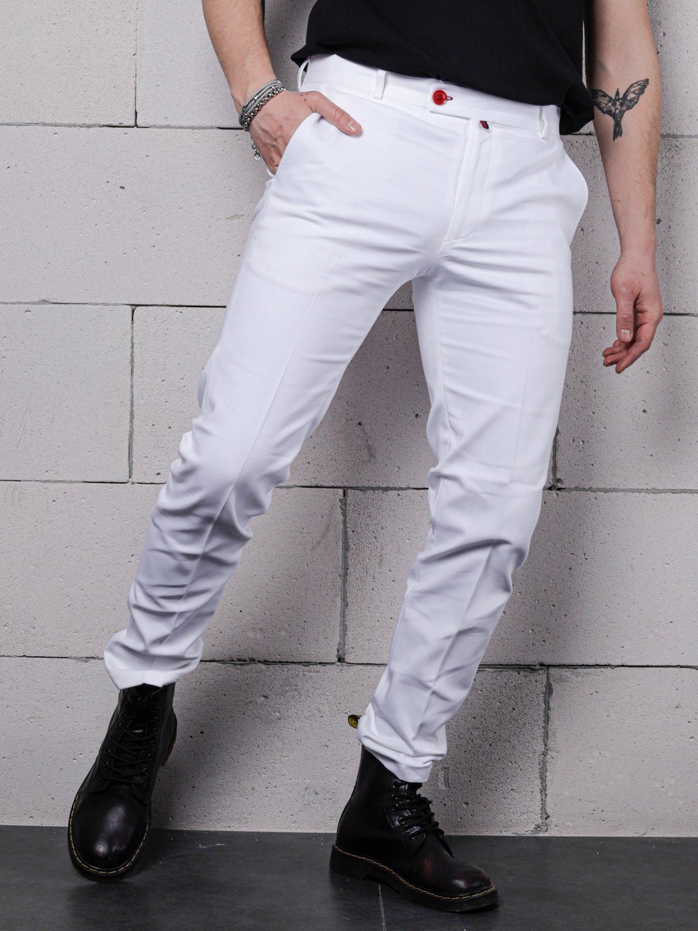 A man wearing a black shirt and CREAM FRAPPUCCINO PANTS.