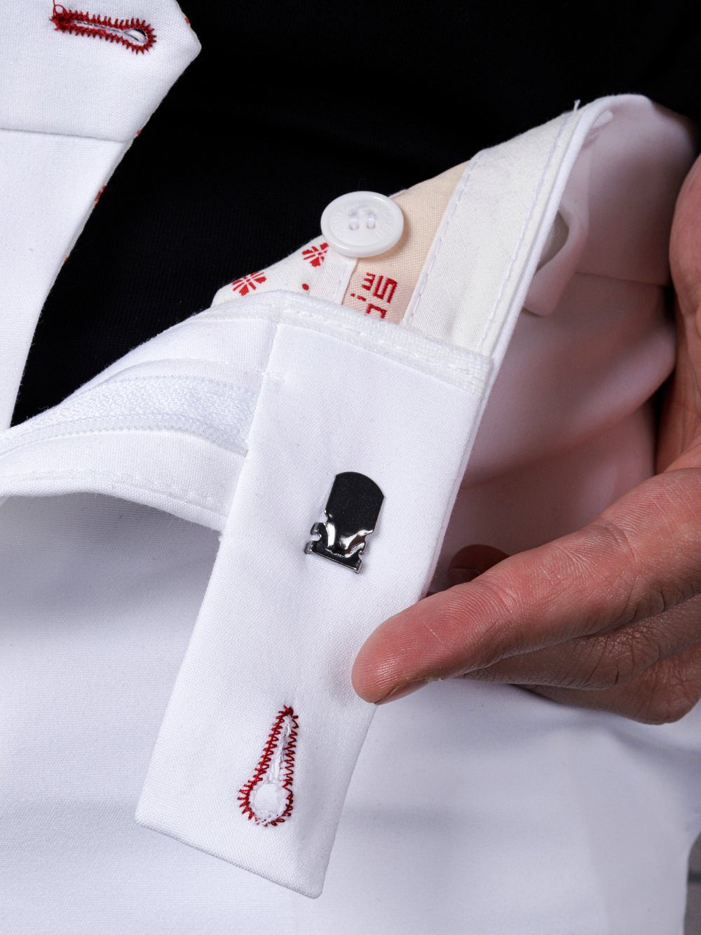 A man wearing CREAM FRAPPUCCINO PANTS with red cufflinks.