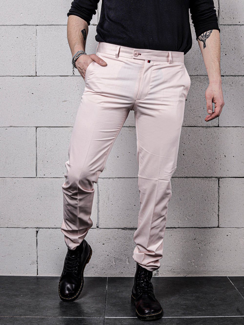 A man wearing CANDY DUST PANTS and a black shirt.