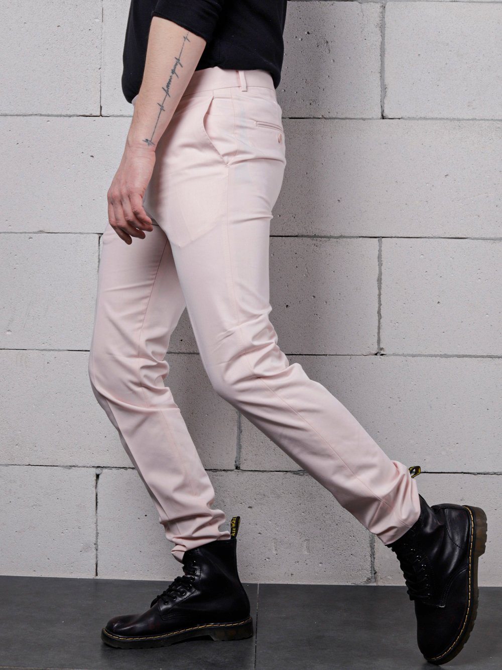A man wearing CANDY DUST PANTS and black boots.