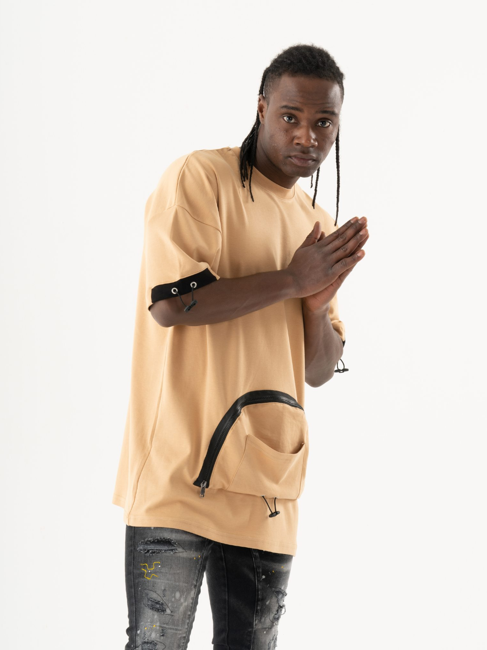 A man wearing a MOSCO T-SHIRT and ripped jeans.