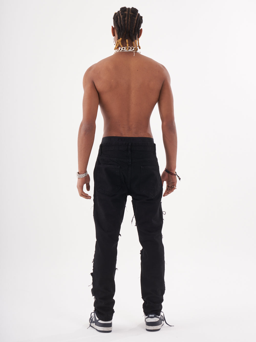 Full body shot of a man in a black color BLUEPRINT streetwear jeans by SERNES