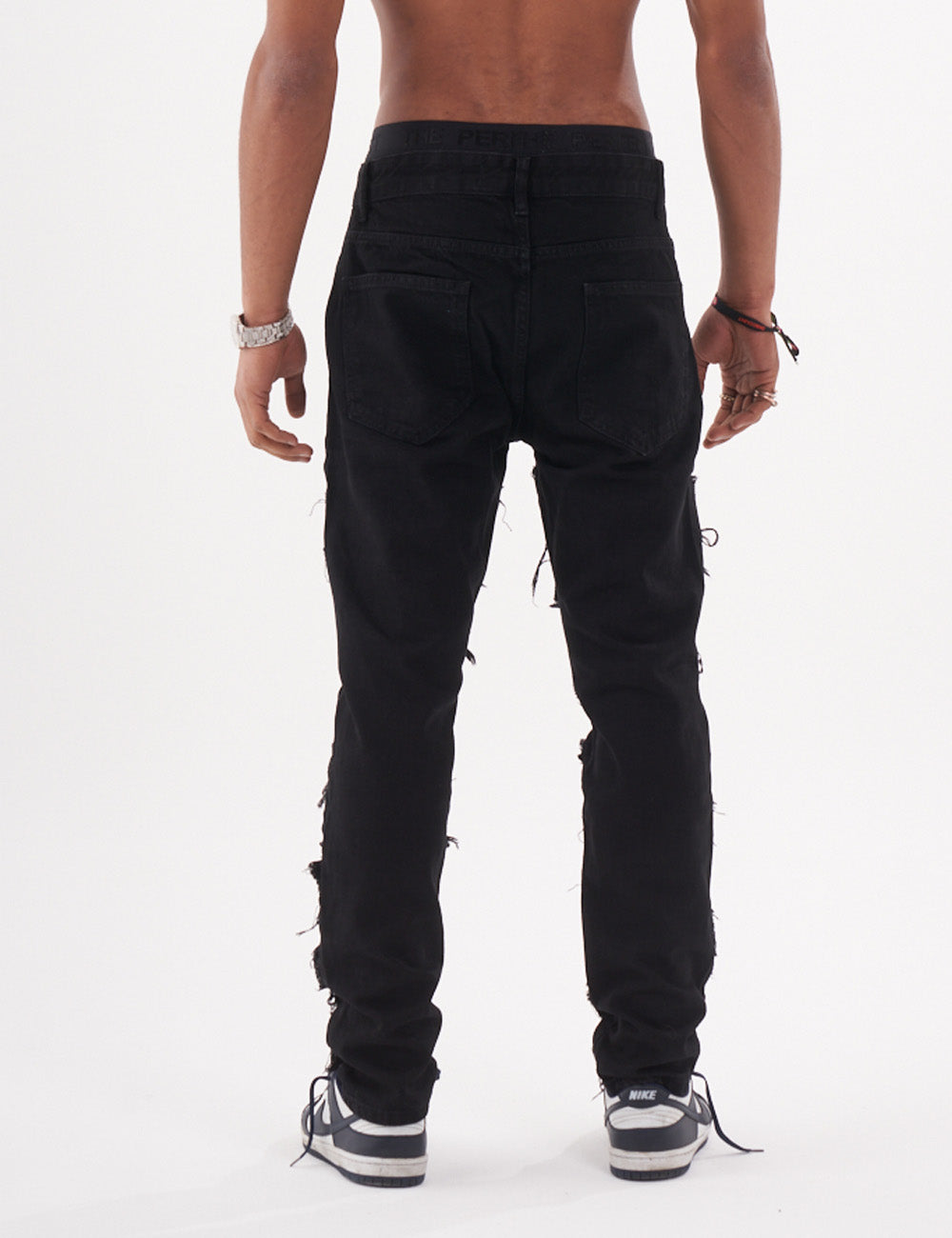 Lower body shot of a man in a black color BLUEPRINT streetwear jeans by SERNES