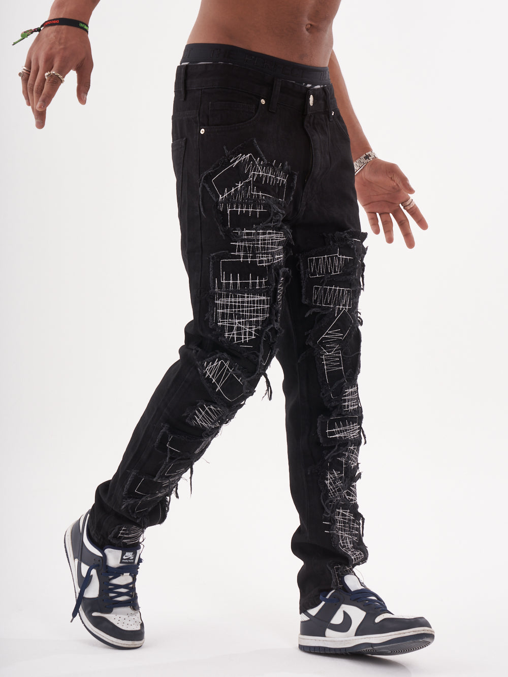 Lower body shot of a man in a black color BLUEPRINT streetwear jeans by SERNES