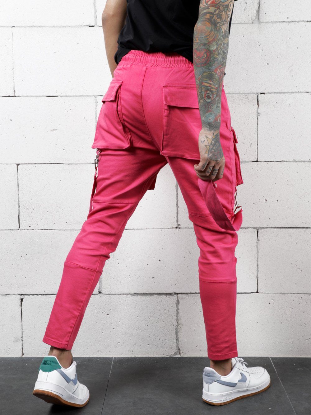 A man wearing PINK BRONX cargo pants and a black t-shirt.