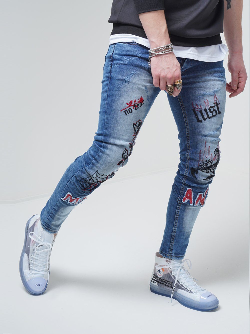 Lower body shot of a man wearing ROSE TATTOO skinny jeans