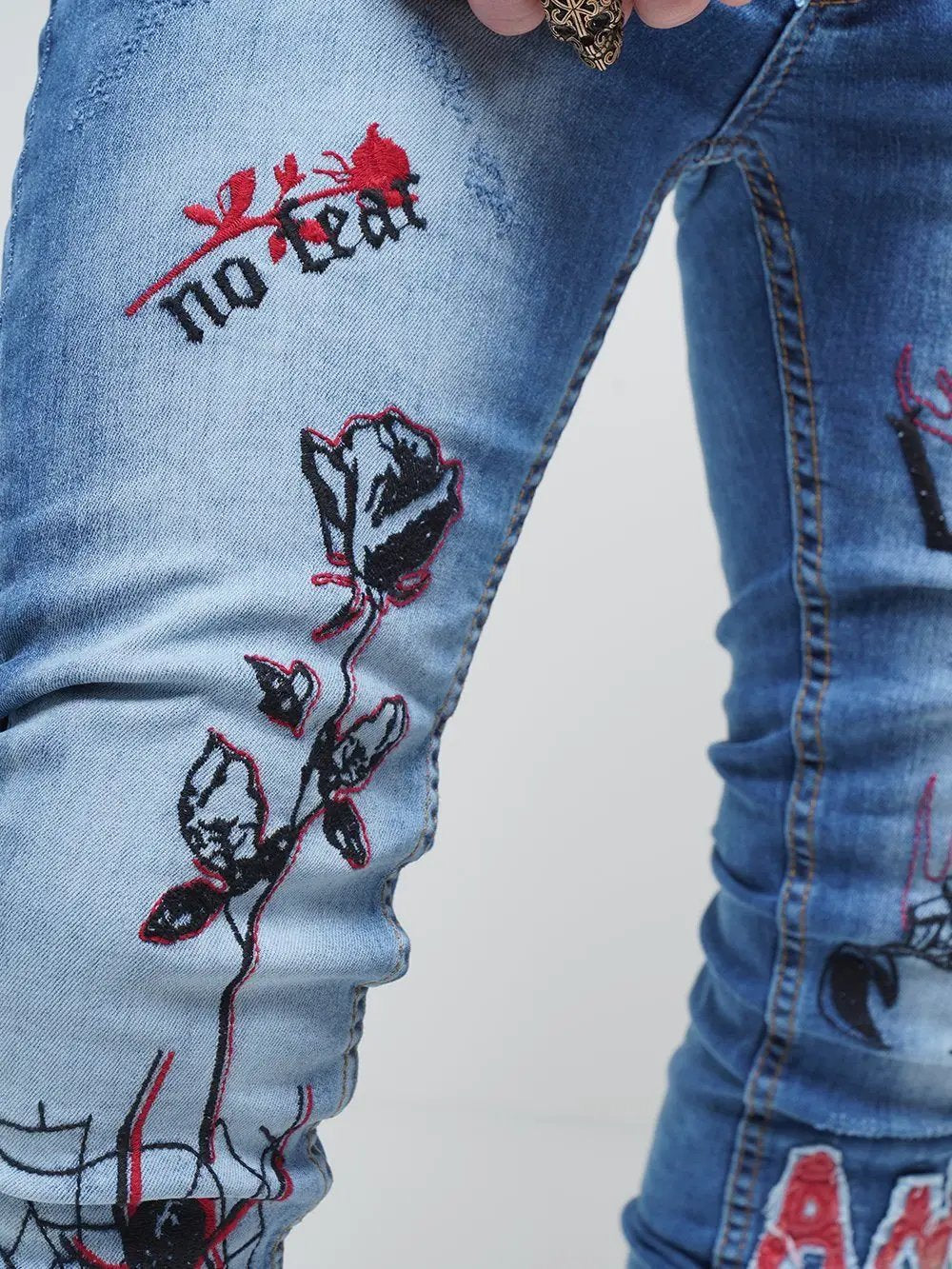 Lower body shot of a man wearing ROSE TATTOO skinny jeans