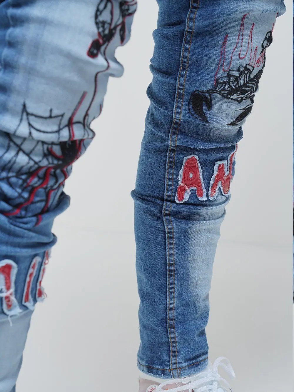 Lower body shot of a man wearing ROSE TATTOO skinny jeans