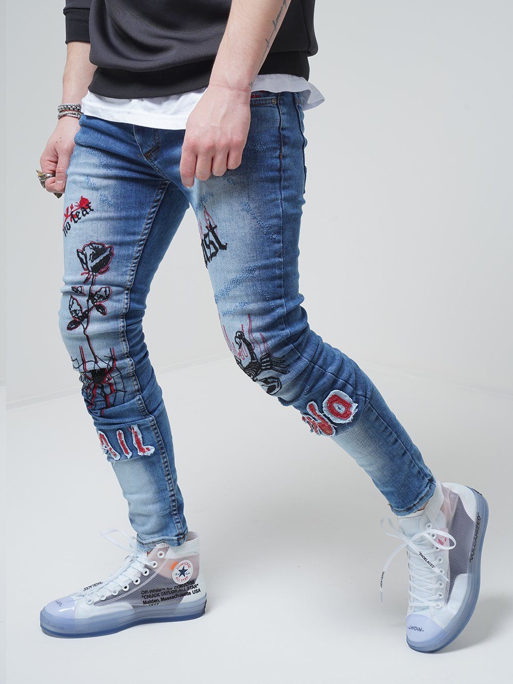 Lower body shot of a man wearing ROSE TATTOO skinny jeans